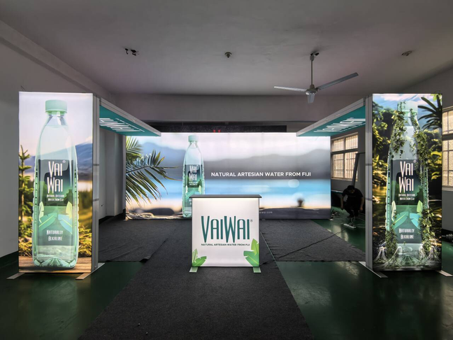 20x20 Custom Backlit Design Booth with SEG Walls, Illuminated Arch, and Modular Display Counter